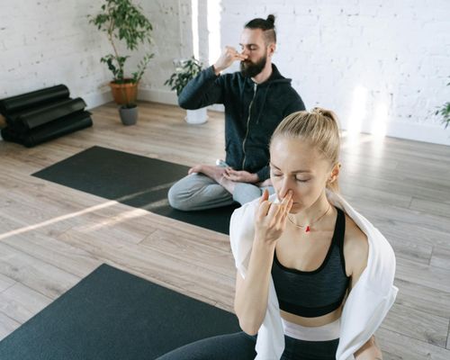 Person breathing deeply in a meditative yoga pose.